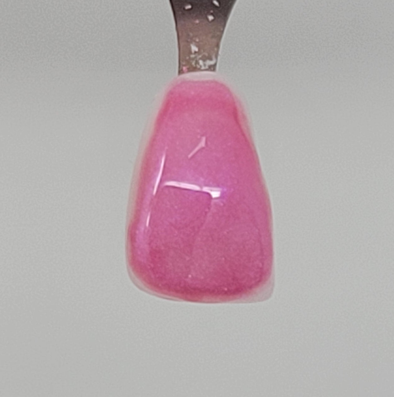 Bubble Gum Pink Temporary Tattooth Colorant on a demo tooth.  These colorants can be applied to teeth to temporarily alter their color or iridescence.