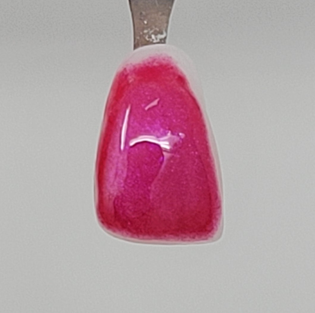 Dark Pink Temporary Tattooth Colorant on a demo tooth.  These colorants can be applied to teeth to temporarily alter their color or iridescence.