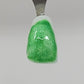 Green Clover Temporary Tattooth Colorant on a demo tooth.  These colorants can be applied to teeth to temporarily alter their color or iridescence.