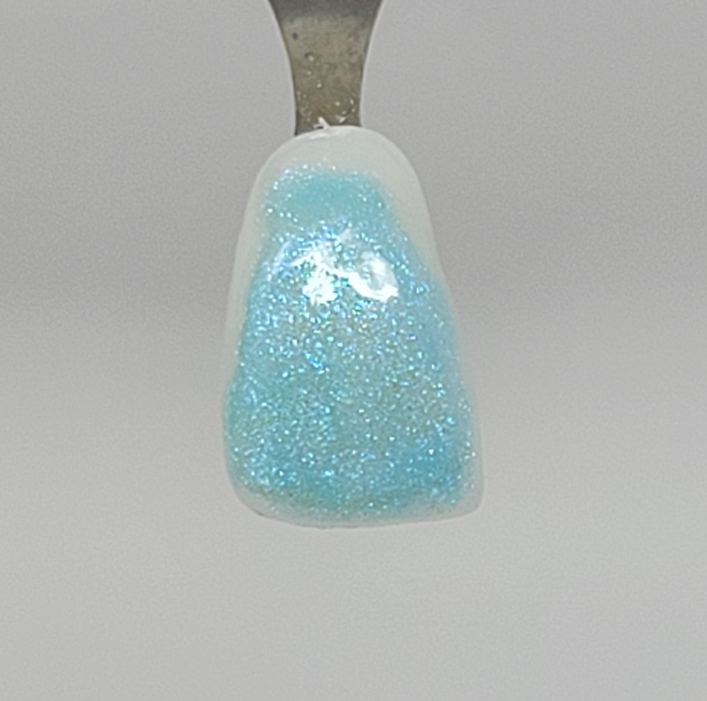 Sky Opal Temporary Tattooth Colorant on a demo tooth.  These colorants can be applied to teeth to temporarily alter their color or iridescence.